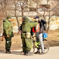 Donetsk People’s Militia troops check men leaving Mariupol for tattoos of swastikas, runes and wolfsangels marking them as neo-Nazi combatants.
