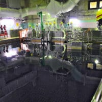 | image shows 2013 IAEA team member overseeing TEPCO moving nuclear fuel assemblies from Reactor Unit 4 to the Common Spent Fuel Pool Photo IAEA | MR Online