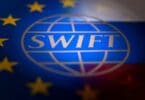 Swift logo is pictured with EU and Russian flags in this illustration picture taken February 26, 2022.
