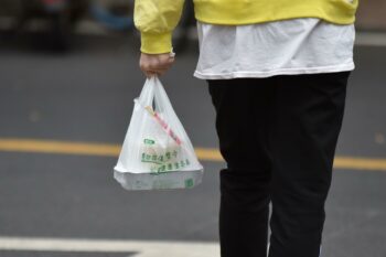 A biodegradable plastic takeaway bag in Hainan. There is no binding national standard for “biodegradable” plastics in China, so their quality varies widely; two types can even degrade into microplastics. (Image: Lu Junming/Alamy)