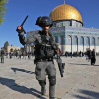 | A member of the Israeli security forces attacks worshippers at the Dome of the Rock mosque during clashes at Jerusalems alAqsa Mosque compound on 15 April 2022 AFP | MR Online