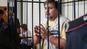 Ruslan Kotsaba, Ukrainian journalist and conscientious objector, in a cage during a recent court trial / credit: friendspeaceteams.org