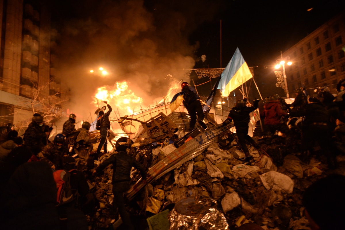 | State flag of Ukraine behind a wall of anonymous protesters in Kyiv Ukraine | MR Online