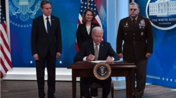 Joe Biden signing measure to ship more weapons to Ukraine on March 16, 2022. [Source: english.alarabiya.net]