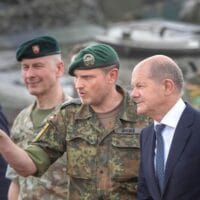 German Chancellor Olaf Scholz, right, talks with Lieutenant Colonel Daniel Andrä, commander of the multinational NATO Enhanced Forward Presence (EFP) battalion at the military training area near Prabade in Lithuania [AP Photo/Mindaugas Kulbis] [AP Photo/Mindaugas Kulbis]