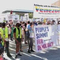 The march about to start with People’s Summit banner along with a banner of solidarity with Venezuela. Photo: Rick Sterling.