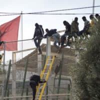  | African migrants sit on top of a border fence during an attempt to cross from Morocco into Spains north African enclave of Melilla November 21 2015 Photo ReutersJesus Blasco de AvellanedaFile Photo | MR Online