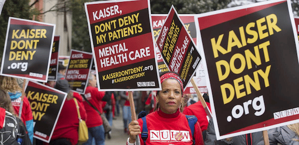 MR Online | After whistleblowing short strikes and a year of contract negotiations Kaiser mental health workers are on their first ever open ended strike They say patients shouldnt have to wait months for a therapy appointment Photo NUHW | MR Online