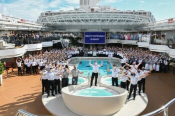 Staff pose aboard the deck of the MS Nieuw Statendam, a Pinnacle-class cruise ship operated by Holland America Line, 2018. Photo courtesy Holland America Line.