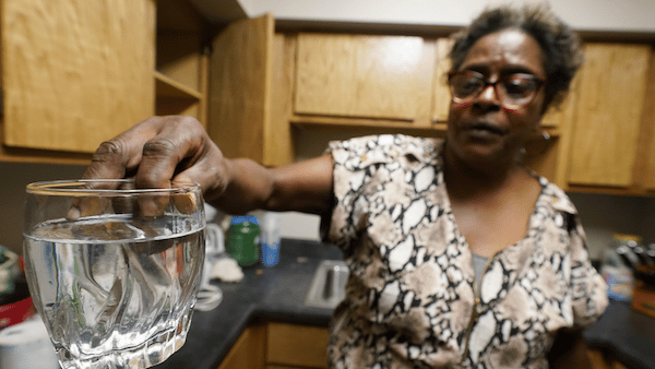| A resident displays contaminated water in her kitchen in Jackson Miss AP PhotoSteve Helber | MR Online