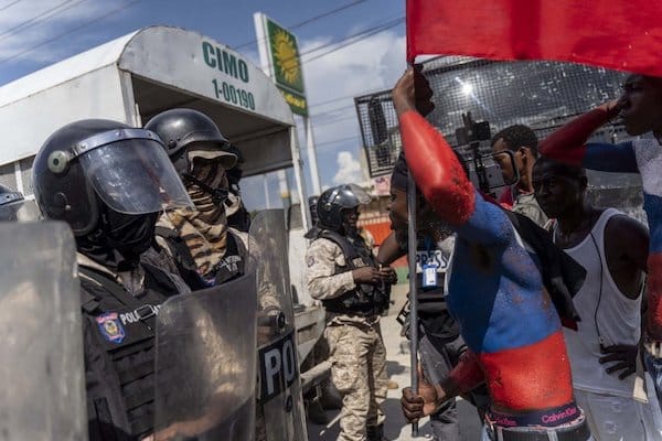 | A protester taunts police officers during Jean Jacques Dessalines Day in Port au Prince Haiti October 17 2022 courtesy AFP | MR Online
