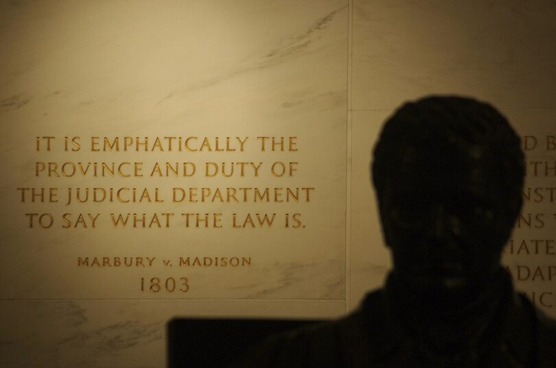 | First Floor at the Statute of John Marshall in the foreground shadowed quotation from Marbury v Madison written by Marshall engraved into the wall United States Supreme Court Building Image swatgesture Source Wikimedia Commons | MR Online
