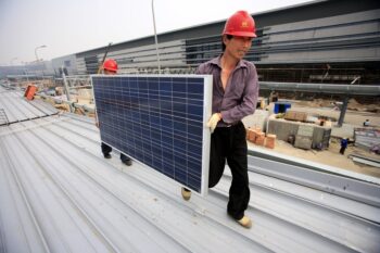 | RED SUN Workers install solar panels on Shanghai workplaces CC FlickrJiri Rezac | MR Online