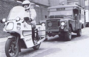 | A West Midlands Police motorcyclist escorts a British Army ambulance during the 1989 90 strike Photo by West Midlands Police CC BY SA 20 | MR Online