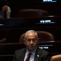 Israeli Prime Minister-designate Benjamin Netanyahu pauses during a session after Yariv Levin was selected as Speaker of the Knesset on 13 December 2022 (AP)