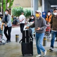 Passengers walk out of Haikou Meilan International Airport on December 9, 2022. Photo: VCG