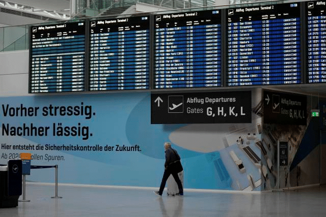 MR Online | Man passing terminal in airport in Munich Germany Photo APAl Mayadeen | MR Online