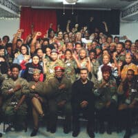 Attendees of the African People’s Socialist Party (APSP) Plenary 2017. In the front row includes recently indicted defendants Gazi Kodzo (first from left with fist on chest) and Omali Yeshitela (third from left with red beret) / credit: The Burning Spear