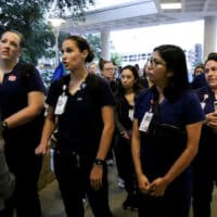 Locked-out Ascension Seton Medical Center nurses in Austin, Texas, confront a representative of the hospital’s administration on June 28. The company locked them out for three days after they struck, but the move backfired. Photo: National Nurses United.