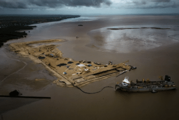 A ship creates an artificial island to serve as a port for offshore oil production at the mouth of the Demerara River in Georgetown Guyana on April 12 2023 Photo Matias DelacroixAP