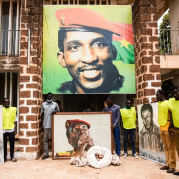 People gather for a ceremony in front of the building where Thomas Sankara was assassinated in 1987 in Burkina Faso April 6 2022 Sophie Garcia | AP