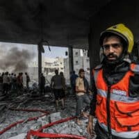 A member of the Palestinian Civil Defense recovers bodies and injured people from under the rubble after an Israeli airstrike in Rafah, in southern Gaza, on October 17th, 2023. Abed Rahim Khatib/dpa/Alamy Live News