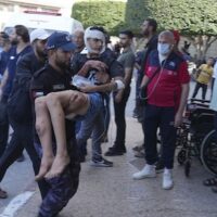 Palestinians wounded in Israeli airstrikes are brought to a hospital in Deir al-Balah, south of the Gaza Strip, October 15, 2023