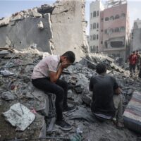 A young person mourning after an Israeli attack that struck a refugee camp in Gaza City on Nov. 2, 2023. So far, more than 9,000 Palestinians have been killed by the Israeli military. PHOTO BY MUSTAFA HASSONA/ANADOLU VIA GETTY IMAGES