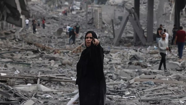  | Palestinians walk through debris amid the destruction from Israeli airstrikes in Gaza Citys al Rimal neighbourhood on 10 October 2023 AFP | MR Online