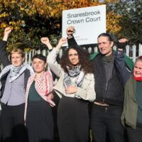 Palestine Action defendants including Huda Ammori (4th from right) outside court. (Photo: Martin Pope via Getty / Declassified UK)