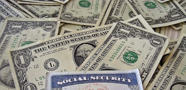 MR Online | A social security card on a bed of money | MR Online