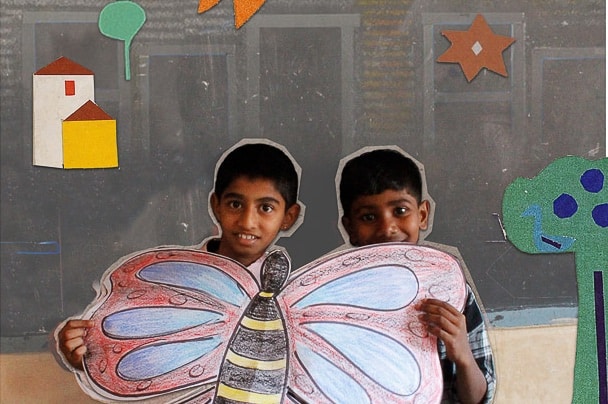 MR Online | Students display a butterfly they made at the Madu Adu science or lets do it corner Credit Photographs and collages by Tricontinental Institute for Social Research | MR Online