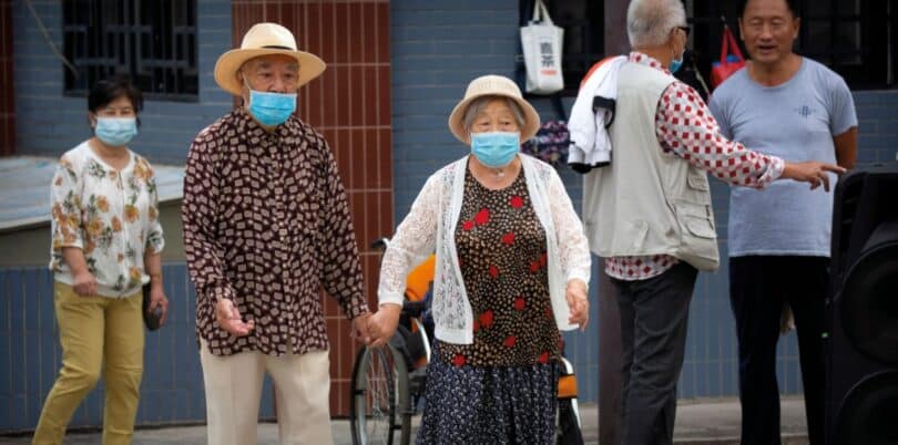 | COVID V CHINA An elderly couple wearing face masks to protect against the coronavirus walk in a park in Beijing 2020 | MR Online