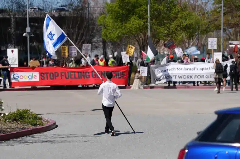 MR Online | A counter protester holding an Israeli flag walks into the car park near a protest at Google Cloud offices in Sunnyvale California on April 16 2024 File ReutersNathan Frandino | MR Online