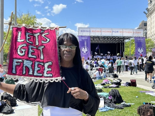 MR Online | Avis Lee holds a banner for Lets Get Free the Women and Trans Prisoner Defense Committee which helped with her fight for freedom and with which she now organizes to free others | MR Online