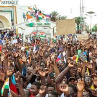 Nigeriens demonstrate during a rally at the Place de la Concertation in front of the headquarters of the National Assembly on 20 August 2023 in Niamey. They are supporting the National Council for the Safeguard of the Party (CNSP), which is threatened with military intervention by the Economic Community of West African States (ECOWAS) following their coup against the democratically elected president, Mohamed Bazoum, who is being held captive in his presidential residence. (Photo by: Souley Abdoulaye/Afrikimages Agency/Universal Images Group via Getty Images)