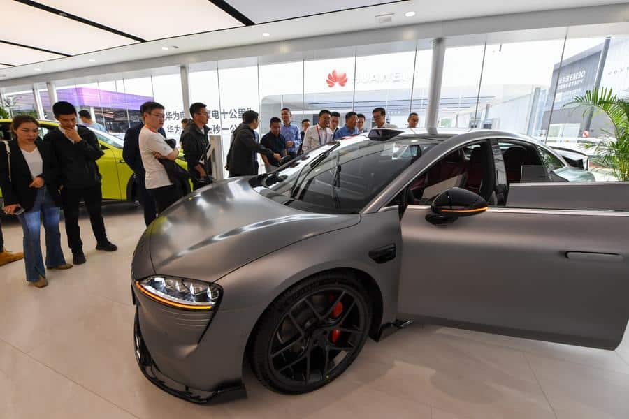 Visitors watch a new energy vehicle equipped with Huawei's Qiankun system at the 2024 Beijing International Automotive Exhibition in Beijing, China, April 25, 2024. (Xinhua/Ju Huanzong)