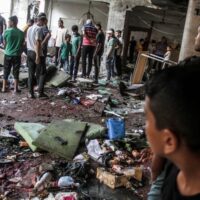 Palestinians search for victims after an Israeli attack that killed more than 100 people at a school in Gaza City on 10 August. Mahmoud Zaki UPI