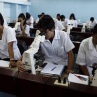 Medicine students look through microscopes at a laboratory of the Latin American School of Medicine in Havana. | Javier Galeano / AP