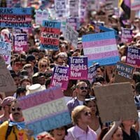 Demonstrators hold placards during a London Trans Pride protest. (Photo by Hollie Adams/Getty Images)