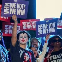 Attendees hold up signs during a campaign rally with Democratic presidential nominee and US Vice President Kamala Harris at Craig Ranch Amphitheater, Las Vegas, Nevada, on 31 October 2024 (Ethan Miller/Getty Images/AFP)