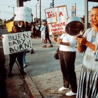 Protesters in Los Angeles after police officers found not guilty in the brutal beating of unarmed Black man, Rodney King. This verdict sparked the 1992 L.A. Uprising.