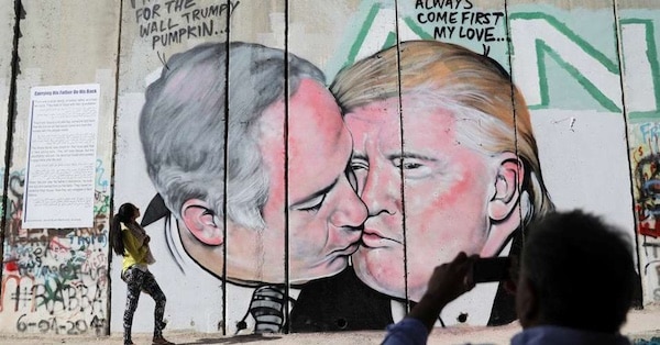 | A massive mural of Israeli Prime Minister Benjamin Netanyahu and US President Donald Trump engaged in a passionate kiss was unveiled Sunday morning October 29 2017 painted on the West Bank security barrier near the West Bank city of Bethlehem REUTERSMussa Qawasma | MR Online