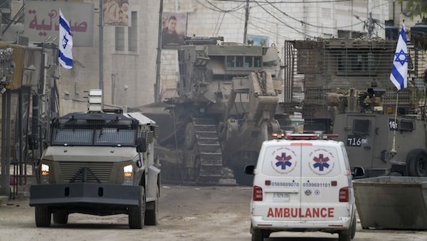 | Israeli military vehicles guard a road where a military bulldozer operates in the West Bank refugee camp of Jenin January 22 2025 AP PhotoMajdi Mohammed | MR Online