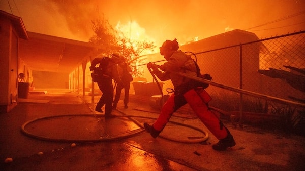  | Firefighters protect a structure as the Eaton Fire advances Wednesday January 8 2025 in Altadena California AP PhotoEthan Swope | MR Online