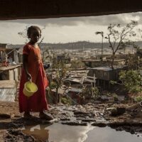 A young girl walks in the Kaweni slum on the outskirts of Mamoudzou, in the French Indian Ocean island of Mayotte, December 19, 2024, after Cyclone Chido