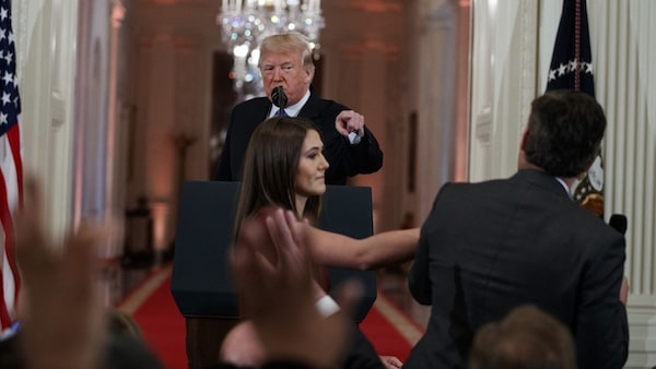  | In this November 7 2018 file photo President Donald Trump watches as a White House aide reaches to take away a microphone from CNN journalist Jim Acosta during a news conference in the East Room of the White House in Washington AP PhotoEvan Vucci | MR Online