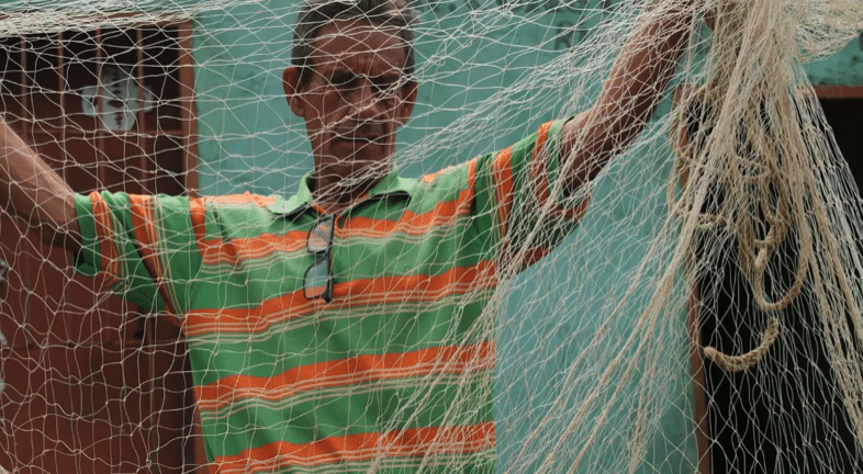 Fisherfolk check the net before going out on the river Rome Arrieche