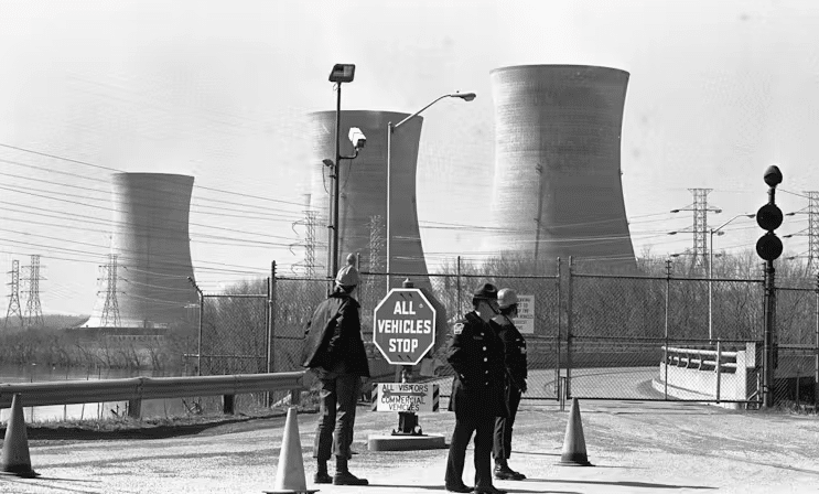 An undated photo showing security standing outside the closed front gate to the nuclear power plant on Three Mile Island near Harrisburg Pa The plant was shut down following a partial meltdown in March 1979 Recently Microsoft signed a 20 year deal with the plant which is set to re open in 2028 AP PhotoPaul Vathis