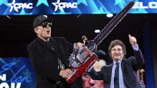  | Elon Musk holds up a chainsaw he received from Argentinas President Javier Milei right as they arrive to speak at the Conservative Political Action Conference CPAC at the Gaylord National Resort  Convention Center Thursday Feb 20 2025 in Oxon Hill Maryland AP PhotoJose Luis Magana | MR Online